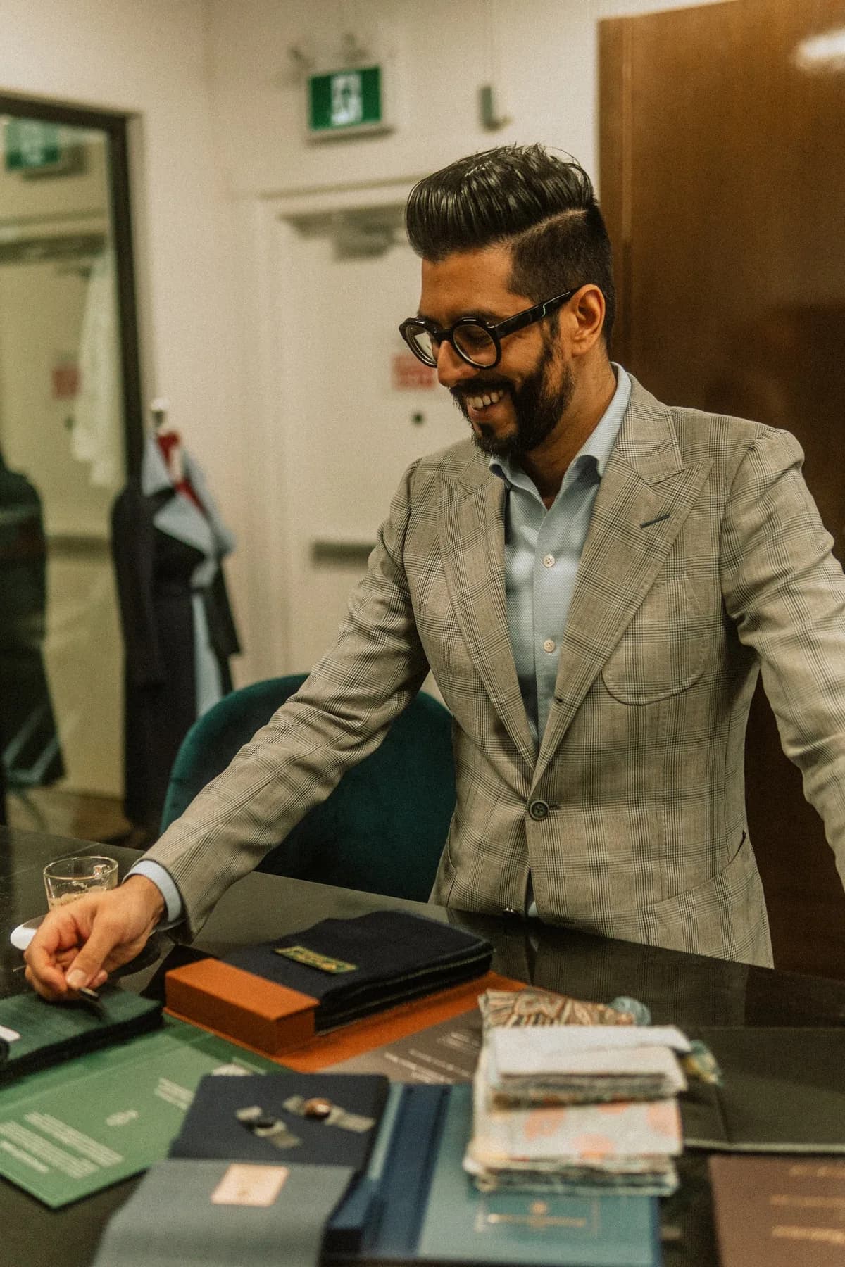 Kunal welcoming clients at the cloth table in the Toronto atelier