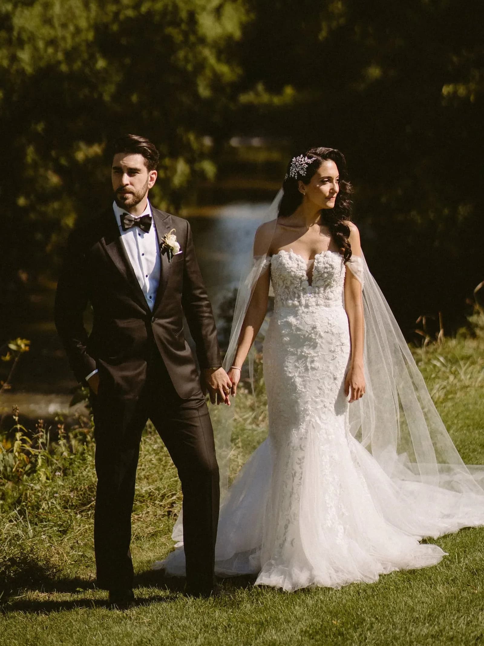 A couple on their wedding day, the groom wearing a custom tuxedo